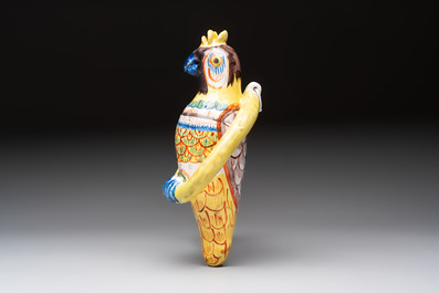 A white Dutch Delft cow milker group and a polychrome Dutch Delft parrot, 18/19th C.