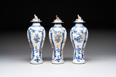 Three Chinese famille rose 'mandarin subject' vases and covers, Qianlong