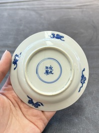 Eight Chinese blue, white and iron-red cups and twelve saucers, Kangxi/Yongzheng
