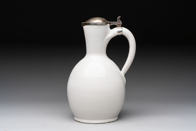 A fine white-glazed Delftware jug with silver cover, 17th C.