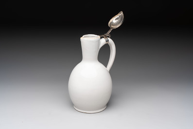 A fine white-glazed Delftware jug with silver cover, 17th C.