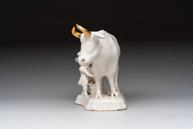 A white Dutch Delft cow milker group and a polychrome Dutch Delft parrot, 18/19th C.