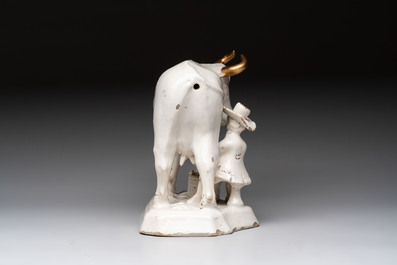 A white Dutch Delft cow milker group and a polychrome Dutch Delft parrot, 18/19th C.