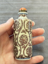 Two Chinese blue, white and copper-red snuff bottles and two blue and white snuff bottles, 19th C.