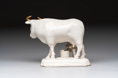 A white Dutch Delft cow milker group and a polychrome Dutch Delft parrot, 18/19th C.