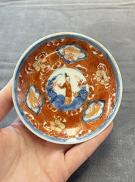 Eight Chinese blue, white and iron-red cups and twelve saucers, Kangxi/Yongzheng