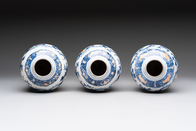 Three Chinese famille rose 'mandarin subject' vases and covers, Qianlong