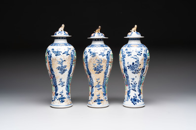 Three Chinese famille rose 'mandarin subject' vases and covers, Qianlong