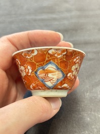Eight Chinese blue, white and iron-red cups and twelve saucers, Kangxi/Yongzheng