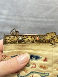 A Chinese embroidered silk purse with red coral- and turquoise-inlaid gilt-bronze mounts, Qing