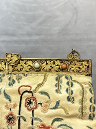 A Chinese embroidered silk purse with red coral- and turquoise-inlaid gilt-bronze mounts, Qing