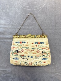A Chinese embroidered silk purse with red coral- and turquoise-inlaid gilt-bronze mounts, Qing