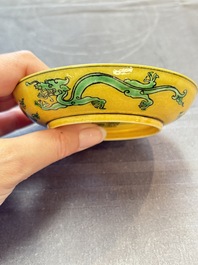 A Chinese yellow-ground aubergine and green-enamelled 'dragon' saucer, Daoguang mark and of the period