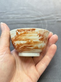A Chinese iron-red-decorated 'Deer Hunting' bowl and two cups, Qianlong
