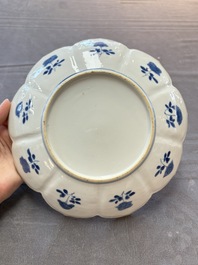 A pair of Chinese blue and white lotus-form 'grasshopper' plates, Kangxi