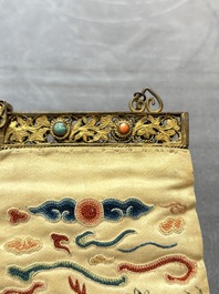 A Chinese embroidered silk purse with red coral- and turquoise-inlaid gilt-bronze mounts, Qing