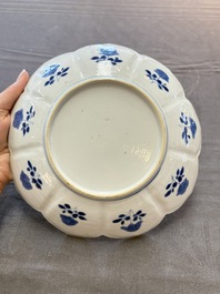 A pair of Chinese blue and white lotus-form 'grasshopper' plates, Kangxi