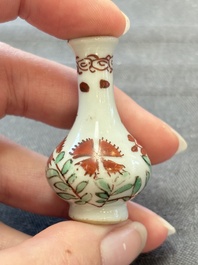 Eight Chinese wucai and gilt-iron-red miniature vases with floral design, Kangxi