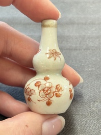 Eight Chinese wucai and gilt-iron-red miniature vases with floral design, Kangxi