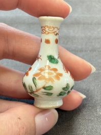 Eight Chinese wucai and gilt-iron-red miniature vases with floral design, Kangxi