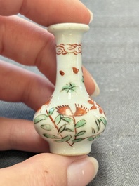 Eight Chinese wucai and gilt-iron-red miniature vases with floral design, Kangxi