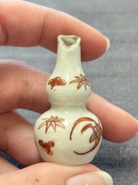 Eight Chinese wucai and gilt-iron-red miniature vases with floral design, Kangxi