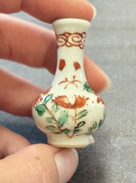 Eight Chinese wucai and gilt-iron-red miniature vases with floral design, Kangxi