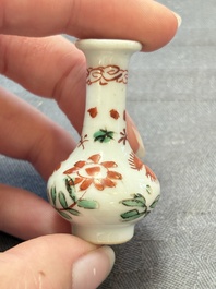 Eight Chinese wucai and gilt-iron-red miniature vases with floral design, Kangxi