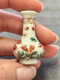 Eight Chinese wucai and gilt-iron-red miniature vases with floral design, Kangxi