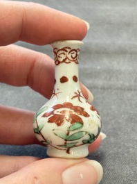 Eight Chinese wucai and gilt-iron-red miniature vases with floral design, Kangxi