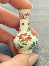 Eight Chinese wucai and gilt-iron-red miniature vases with floral design, Kangxi