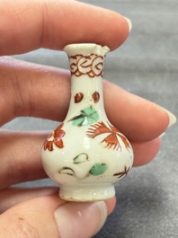 Eight Chinese wucai and gilt-iron-red miniature vases with floral design, Kangxi