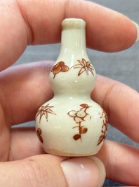 Eight Chinese wucai and gilt-iron-red miniature vases with floral design, Kangxi