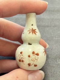 Eight Chinese wucai and gilt-iron-red miniature vases with floral design, Kangxi