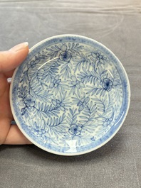 Ten Chinese blue and white cups and eleven saucers, Kangxi