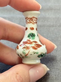 Eight Chinese wucai and gilt-iron-red miniature vases with floral design, Kangxi