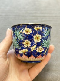 A pair of Chinese blue-ground Canton enamel covered bowls on stands and an egg cup, Qianlong/Jiaqing
