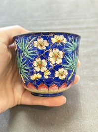 A pair of Chinese blue-ground Canton enamel covered bowls on stands and an egg cup, Qianlong/Jiaqing