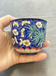 A pair of Chinese blue-ground Canton enamel covered bowls on stands and an egg cup, Qianlong/Jiaqing
