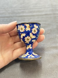 A pair of Chinese blue-ground Canton enamel covered bowls on stands and an egg cup, Qianlong/Jiaqing