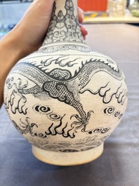 A Chinese black-enamelled biscuit 'dragon' vase, Kangxi mark, 19th C.