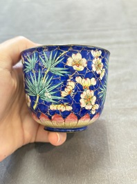 A pair of Chinese blue-ground Canton enamel covered bowls on stands and an egg cup, Qianlong/Jiaqing