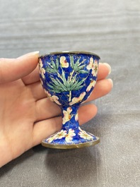 A pair of Chinese blue-ground Canton enamel covered bowls on stands and an egg cup, Qianlong/Jiaqing
