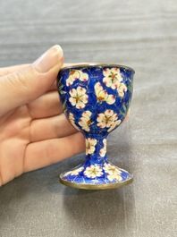 A pair of Chinese blue-ground Canton enamel covered bowls on stands and an egg cup, Qianlong/Jiaqing