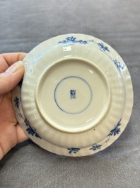 A set of six Chinese blue and white cups and saucers with floral design, Kangxi