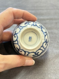 A set of six Chinese blue and white cups and saucers with floral design, Kangxi