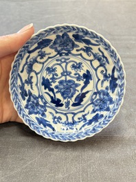 A set of six Chinese blue and white cups and saucers with floral design, Kangxi
