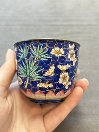 A pair of Chinese blue-ground Canton enamel covered bowls on stands and an egg cup, Qianlong/Jiaqing
