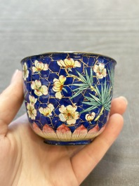 A pair of Chinese blue-ground Canton enamel covered bowls on stands and an egg cup, Qianlong/Jiaqing