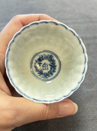 A set of six Chinese blue and white cups and saucers with floral design, Kangxi